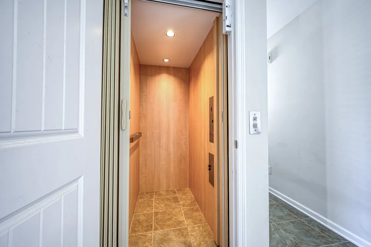 This interior image focuses on the modern elevator, featuring textured walls and contemporary lighting. The elevator is spacious and inviting, suggesting easy mobility for all guests, including seniors and those with strollers or beach gear.